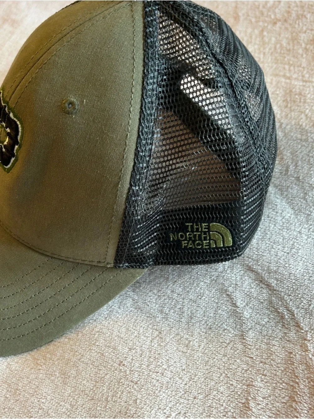 The North Face green with black mesh trucker hat P on the front OSFA